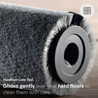 A close-up of the Miele Triflex HX2 Pro 3-in-1 Cordless Stick Vacuum’s cylindrical hard floor care tool showcases its dense gray bristles, engineered by Miele for gentle yet effective floor cleaning. The text highlights its smooth gliding action that carefully cleans hard floors, making this accessory an essential part of modern cordless upright vacuum technology.