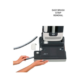 Close-up of hands removing a brush strip from the SEBO 350 Mechanical by Sew & Vac, featuring "Easy Brush Strip Removal" for efficient pet hair removal.