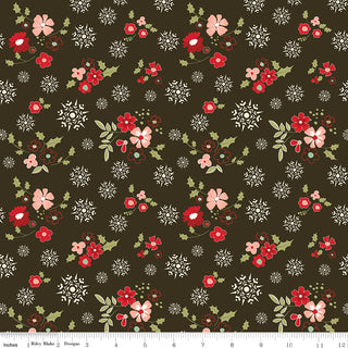 Glisten by Sandy Gervais C16222-MOCHA for Riley Blake features dark brown cotton with red/pink flowers, green leaves, and white snowflakes. Shown with ruler for scale. Sold by the yard, 43/44” wide.