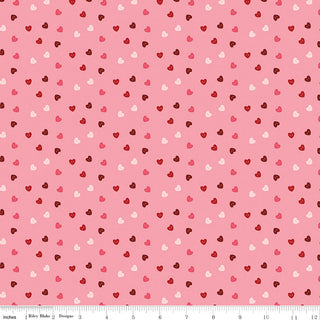 Sew in Love Dani Mogstad for RBD Rose Hearts Yardage C16905-ROSE by Riley Blake features pink cotton fabric with scattered hearts in red, dark pink, light pink, and white. 44/45" wide, shown with ruler. Free shipping on your order!.