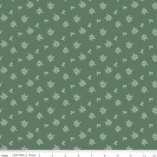 Riley Blake Morning Latte Ditsy Green C16926-GREEN Fabric Yardage by Fabric by Riley Blake features small white floral clusters on green, a ruler showing inches 0-12 along the bottom, and is made from 100% cotton.
