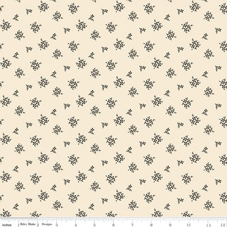 Riley Blake Morning Latte Ditsy Latte C16926-LATTE fabric by Fabric by Riley Blake features small black floral clusters on beige 100% cotton, with a ruler at the bottom showing inches for scale.