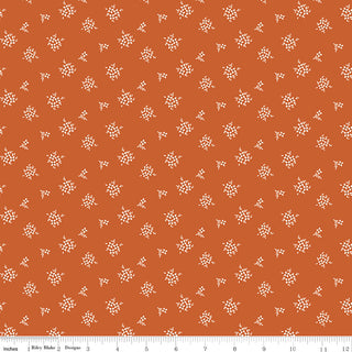 Riley Blake Morning Latte Ditsy Spice C16926-SPICE features orange 100% cotton fabric with a small white floral pattern. A ruler at the bottom of the image shows inch measurements for scale. Brand: Fabric by Riley Blake.