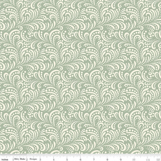Riley Blake Morning Latte Swirls Aloe C16928-ALOE Fabric Yardage by Fabric by Riley Blake features cream swirling shapes and dots on sage green, with a ruler in inches for scale—ideal for your next project.