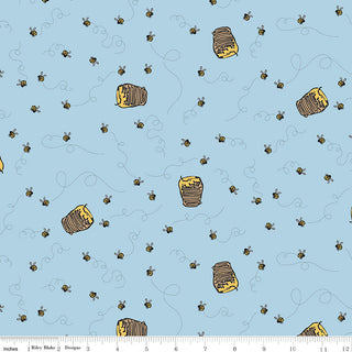 Echo Park for Riley Blake Designs Winnie the Pooh Bees Blue Fabric Yardage C17004-BLUE features light blue fabric with illustrated beehives, bees, and dotted flight paths. Ruler along bottom edge included for scale. By Fabric by Riley Blake.