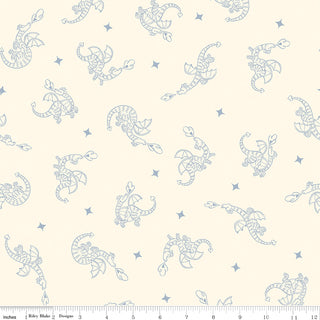 Faraway Kingdom DRAGON FLIGHT SAND C17432-SAND quilting cotton by 56-Riley Blake features cream fabric with repeating light blue dragons and small stars. A ruler in inches is shown at the bottom for scale.