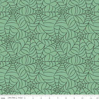 Frank and Friends WEBS GREEN C17474-GREEN by 56-Riley Blake features a green background with black spiderwebs and an inch ruler at the bottom. Ideal Halloween quilting cotton for spooky projects!.