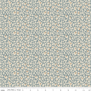 Leo & Savannah by Deena Rutter C17544-BLUE Leopard Blue Fabric Yardage for Riley Blake features abstract beige and cream leopard spots on a muted blue-gray 44" wide cotton quilting fabric, sold by the yard with inch ruler shown along the bottom.
