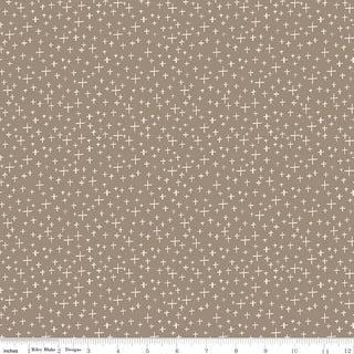 Leo & Savannah by Deena Rutter C17545-TAUPE Criss Cross Taupe Fabric Yardage by Riley Blake is a tan 44"-wide cotton quilting fabric with small white plus signs. Sold by the yard, with an inch-marked ruler along the bottom edge.