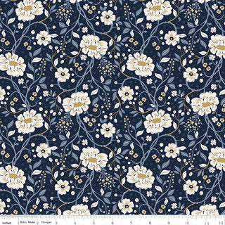 Danelys Sidron for RBD Before the Bloom C18060-INDIGO Main Indigo by 56-Riley Blake features a premium navy blue cotton fabric with a repeating pattern of cream and white flowers, green leaves, and gold accents. This high-quality quilting fabric is displayed with a ruler at the bottom for measurements in inches.