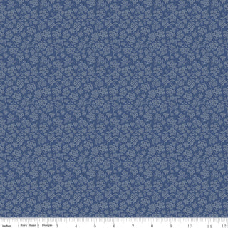Danelys Sidron for RBD Before the Bloom C18063-DENIM Viola Denim by 56-Riley Blake is a premium blue cotton quilting fabric featuring a small, repeating light blue floral pattern. A ruler along the bottom edge displays measurements in inches from 1 to 12. This high-quality cotton fabric is perfect for quilting projects and is available by the yard.