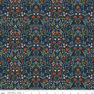 Certainly! Here’s your revised sentence using the product data: Danelys Sidron for Riley Blake Designs’ Before the Bloom C18064-INDIGO Iris Indigo fabric features a repeating floral pattern with orange, blue, and green flowers and leaves set against a dark background. Crafted from premium cotton quilting fabric by 56-Riley Blake, it’s shown with a ruler along the bottom edge in inches to indicate scale—ideal for projects requiring fabric by the yard.