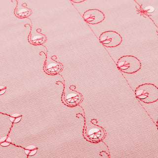 A close up of a Husqvarna Designer Ruby 90 fabric with embroidered designs.