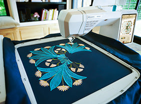 A Sew & Vac Bag of Tricks - Husqvarna Viking Designer Epic 3 machine embroidering a picture of a flower.