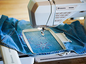 A Sew & Vac Bag of Tricks machine sewing a piece of clothing with the largest embroidery area.