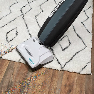 A Simplicity Cordless Freedom S10CV vacuum cleaner is sitting on top of a rug.