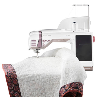 A Husqvarna Viking sewing machine with a quilt on top of it.