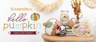 A table displays autumn pumpkin-themed crafts and decor for the Sew & Vac Kimberbell Hello Pumpkin-One Day Event.