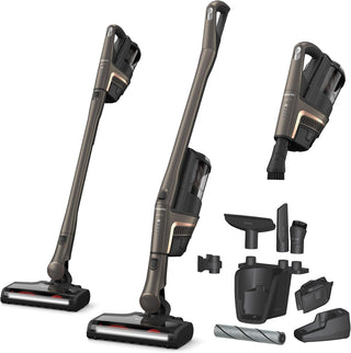 The Miele Triflex HX2 Pro 3-in-1 Cordless Stick Vacuum by 2-Miele is displayed in both upright and handheld modes, showcasing its flexible 3-in-1 design. The image features a variety of cleaning attachments, a charger, two roller brushes, and highlights the built-in HEPA Lifetime Filter set against a white background.