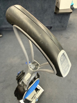 Sew & Vac Oreck Magnesium LW1500RS (Certified Refurbished) vacuum with a black handle, power button, coiled cord, and new HEPA bag shown on a blue carpeted floor.