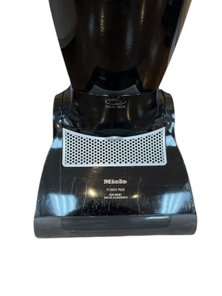 A close-up of a refurbished Miele Upright Dynamic U1 Maverick vacuum head by Imagine Sewing & Vacuum, with visible scuff marks and a SWIVEL NECK label, compatible with multiple cleaning attachments.