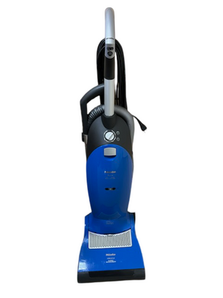 The Miele Upright Dynamic U1 Twist by Imagine Sewing & Vacuum is a blue and black used vacuum with hose attachment, control dial, and cord wrapped around the handle.