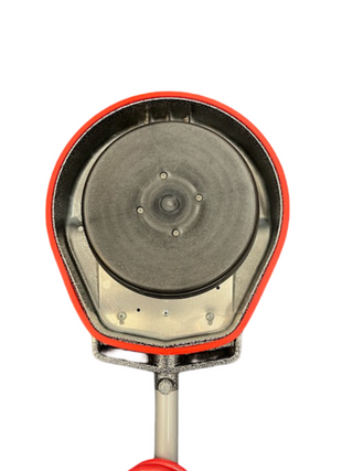 A close-up of the Oreck Orbiter by Imagine Sewing & Vacuum shows its circular metal part mounted in a red, oval frame, viewed from the front against a white background.