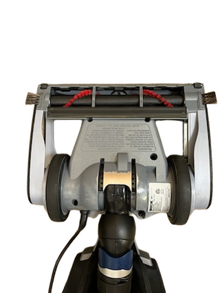 The underside of the Imagine Sewing & Vacuum Oreck Magnesium LW100 lightweight vacuum shows its brush roll, two wheels, and a technical information label.