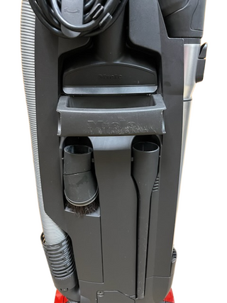 Close-up of the Miele Salsa Upright by Imagine Sewing & Vacuum, highlighting attachments, wrapped power cord, and new filters for optimal performance.