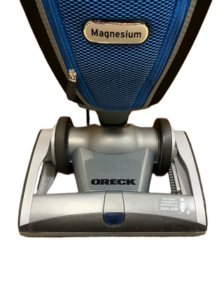 Front view of the Oreck Magnesium upright vacuum cleaner by Imagine Sewing & Vacuum on a white background, delivering reliable cleaning performance.