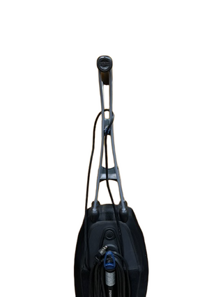 The Oreck Magnesium upright vacuum from Imagine Sewing & Vacuum features a long handle, coiled power cord, and powerful brushroll, shown against a white background.