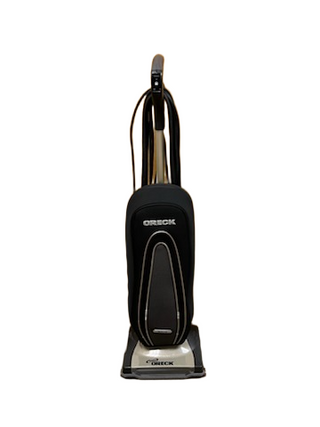 The Oreck Gold Upright from Imagine Sewing & Vacuum, shown with a black and gray body against a white background, features a powerful brushroll for deep cleaning.