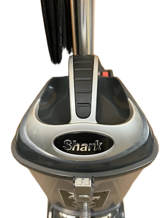 Close-up of the handle and upper section of the Shark Professional Navigator Lift-Away UV550 Upright Vacuum from Imagine Sewing & Vacuum, showcasing the brand logo and control buttons.