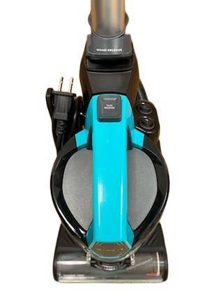 The Imagine Sewing & Vacuum Bissell MultiClean Allergen Lift-Off Pet vacuum has a turquoise handle, black body, power cord, visible wand release button, and a HEPA Sealed Allergen System—shown from above.