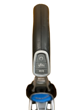 Close-up top view of an Oreck Magnesium vacuum cleaner handle by Imagine Sewing & Vacuum, featuring "Low" and "High" buttons.