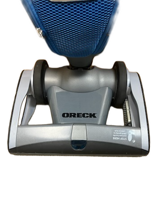 A close-up view of the Oreck Magnesium upright vacuum cleaner head from Imagine Sewing & Vacuum on a white background.