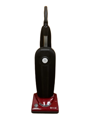 The Riccar R10P, from Imagine Sewing & Vacuum, is a red and black lightweight vacuum cleaner with a handle, shown front-facing on a white background.