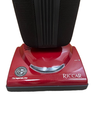 Red Riccar R10P SupraLite upright refurbished vacuum base by Imagine Sewing & Vacuum, featuring the brand logo and visible HEPA bag filtration badge on the front.