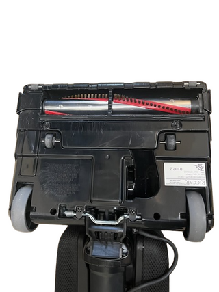 Close-up of the Riccar R10P underside from Imagine Sewing & Vacuum, highlighting the brush roller, wheels, and base.