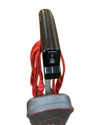 Close-up of a black handle with the power switch set to "off," attached to a refurbished Oreck Commercial U2000RB2L-1 by Imagine Sewing & Vacuum, featuring an extra long red cord wrapped around it.