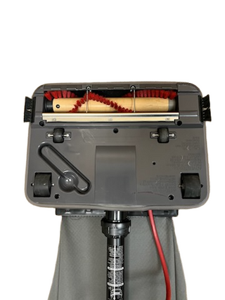 The underside of the Imagine Sewing & Vacuum Oreck Commercial U2000RB2L-1 features a red brush roller, two black wheels, and an extra-long red power cord.