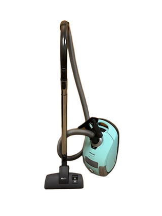 A refurbished Miele Neptune vacuum by Imagine Sewing & Vacuum featuring a turquoise body, black hose, and metal extension wand with floor brush.