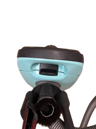 A close-up of the Miele Neptune vacuum cleaner head by Imagine Sewing & Vacuum in teal and black, featuring the nozzle and hose attachment, set against a white background.