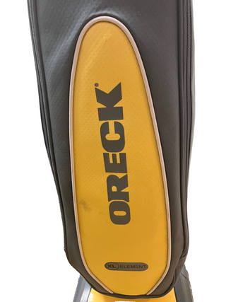 Close-up of an Oreck XL Element vacuum cleaner bag in yellow and gray, featuring the Imagine Sewing & Vacuum brand—perfect for hard floors.