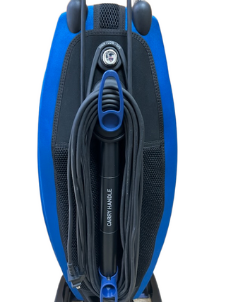 The Oreck Magnesium LW100 by Imagine Sewing & Vacuum is a blue and black upright vacuum cleaner with a front view, power cord wrapped around the handle labeled "CARRY HANDLE," and a never ending belt for lasting performance.