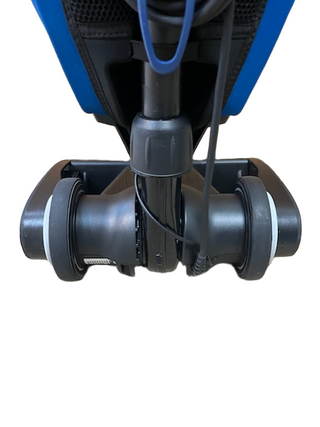 Close-up view of the Oreck Magnesium LW100's wheels and base by Imagine Sewing & Vacuum, highlighting the refurbished vacuum’s bottom section against a white background.