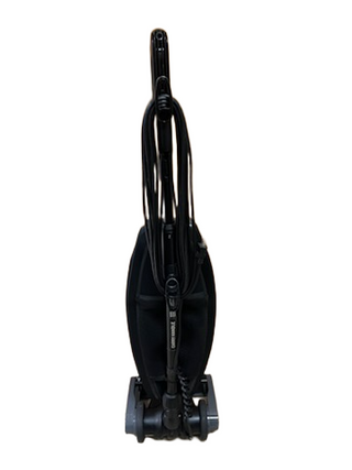 An upright black Oreck Discover vacuum cleaner by Imagine Sewing & Vacuum, reconditioned with a coiled cord, is shown from the front against a white background.