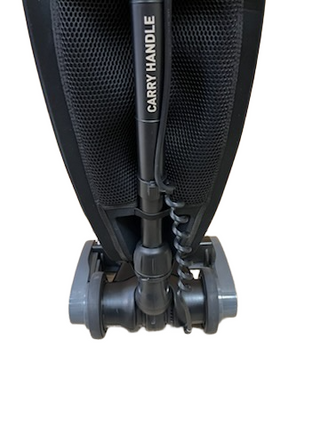 Close-up of the base and handle of an Imagine Sewing & Vacuum Oreck Discover upright refurbished vacuum, with "CARRY HANDLE" printed on the handle.