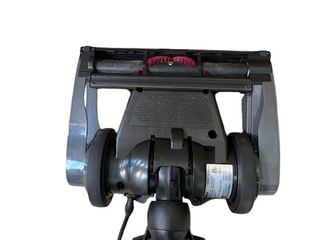 Bottom view of a refurbished Imagine Sewing & Vacuum Oreck Discover vacuum head, featuring wheels, a rotating brush, and a warning label—compatible with the Oreck Discover series.