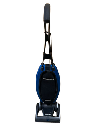 The Oreck Magnesium LW100 vacuum cleaner by Imagine Sewing & Vacuum, featuring a never-ending belt, is displayed upright against a white background in blue and black.
